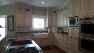 This is an elegant kitchen with dine in island. The island was designed with columns to hide a metal support beam that was built into the kitchen. This island has marble that was flown over from Egyptian mines. All of the appliances in this kitchen are hidden away behind the custom cabinets made and hand finished by Wysocki Brothers. There is a hidden butlers pantry behind the cabinetry as well. Appliances are whirlpool and Subzero Wolf. Absolutely stunning...hard to capture in print.